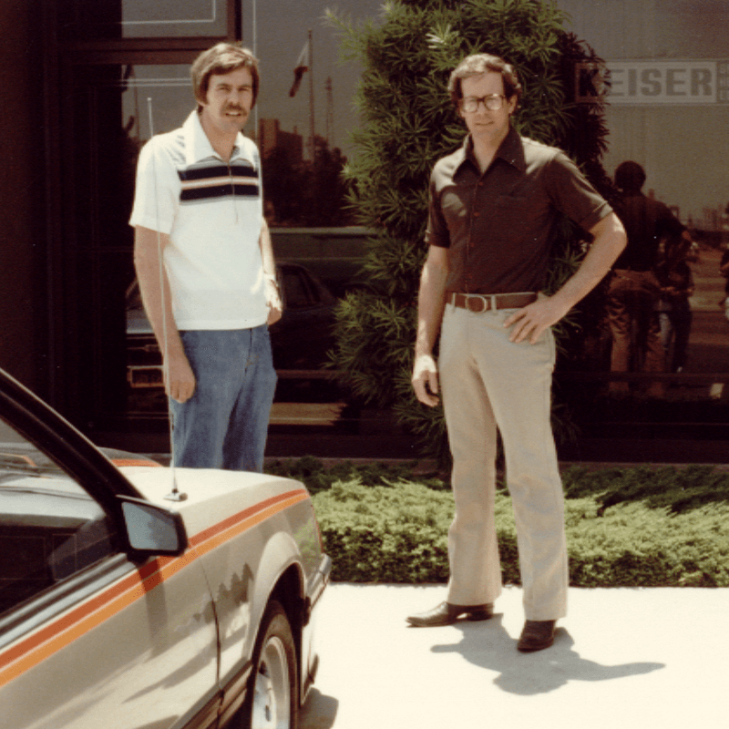 Dennis and Randy standing in front of the original HQ